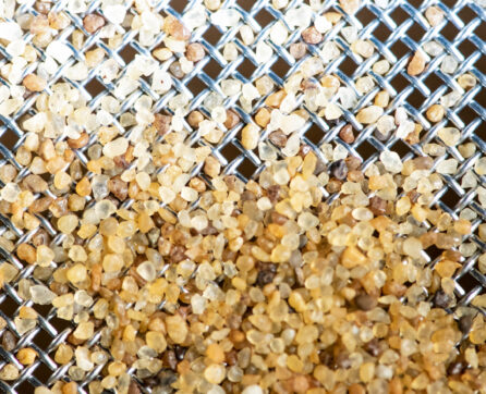 High purity silica sand retained on a 500micron stainless steel woven wire mesh sieve.